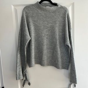Grey sweater with tie sleeves